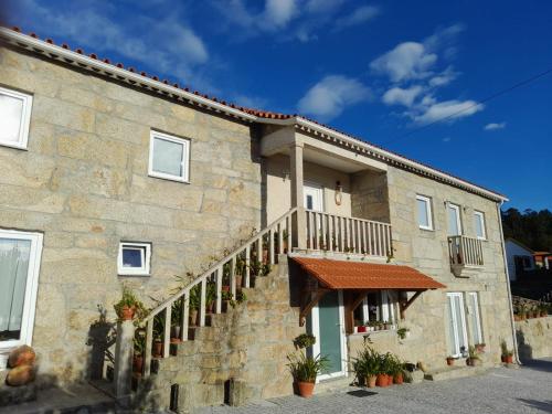a stone building with a staircase in front of it at Alojamento São Lourenço in Viseu