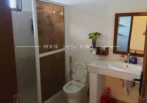 a bathroom with a toilet and a sink and a shower at Villa Changarawe in Mdudu Mkubwa