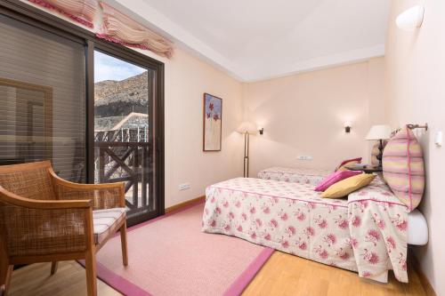 a bedroom with a bed and a window with a view at 3BR Jandia House - Private Pool, Seaviews & Golf in Pájara