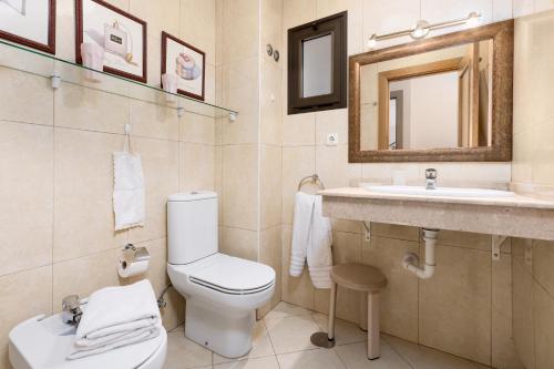 a bathroom with a toilet and a sink at 3BR Jandia House - Private Pool, Seaviews & Golf in Pájara