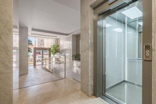 a glass door leading into a hallway with a hallway at Luxury suite Reino de Granada in Granada