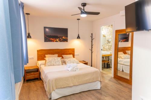 a bedroom with a bed with a teddy bear on it at Hotel Rural La Bodega del Baldomero in San Esteban de Gormaz