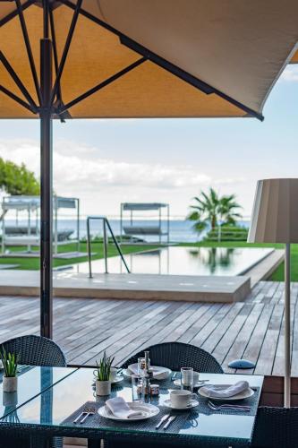 a dining table with a view of the ocean at Hotel de Mar Gran Meliá - Adults Only - The Leading Hotels of the World in Illetas