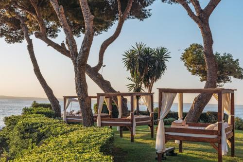 two beds on the beach with the ocean in the background at Hotel de Mar Gran Meliá - Adults Only - The Leading Hotels of the World in Illetas