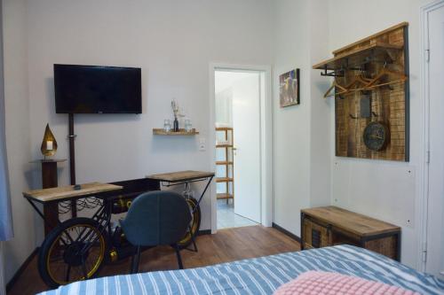 a bedroom with a bed and a desk and a television at Gästehaus Villa Wolff in Bomlitz