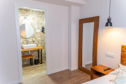 a bathroom with a mirror and a sink in a room at Hotel Rural La Bodega del Baldomero in San Esteban de Gormaz