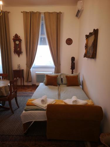 a bedroom with two beds in front of a window at Weisz Castle style Apartment-City Center- Free Private Parking in Carei