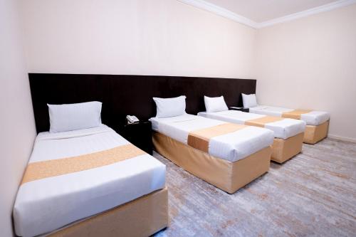 a room with three beds with boxes in it at فندق سيف بلص 2 من اورفانا in Makkah