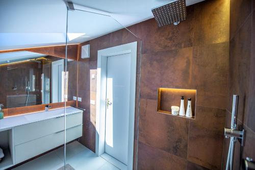a bathroom with a sink and a glass shower at Apartments Raphael in Ortisei