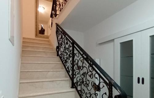 a staircase with a black wrought iron railing at Pet Friendly Home In Vrbnik With Wifi in Vrbnik