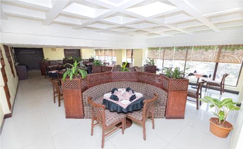 a dining room with a table and chairs at Hotel Garden in Navi Mumbai