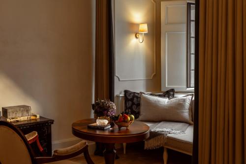a living room with a couch and a table at Rosewood Schloss Fuschl in Hof bei Salzburg