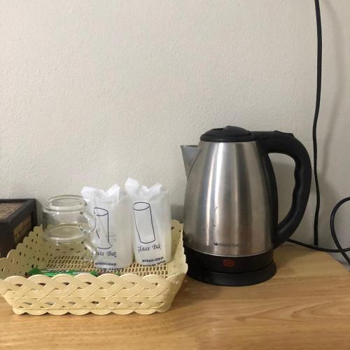 a coffee pot and a basket on a table at Amantra Resort Satun in Ban Prok To Lem