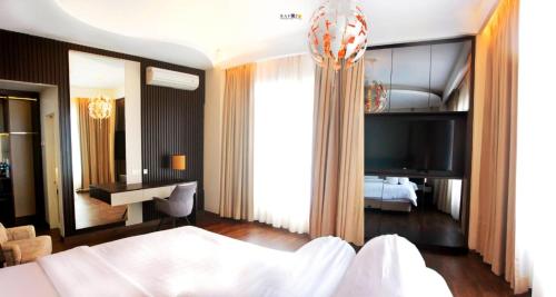 a bedroom with a bed and a desk in a room at Emerald Hotel in Ternate