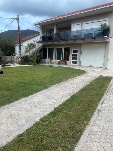 a house with a walkway in front of it at Apartmani Pravilovic II in Bijela