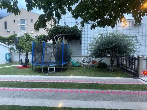 a yard with a playground with a swing at Apartmani Pravilovic II in Bijela