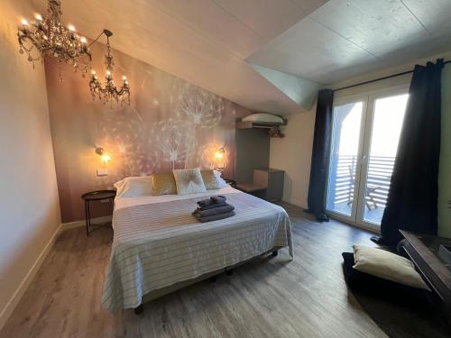 a bedroom with a bed and a large window at Camere e attico al mare in Gabicce Mare