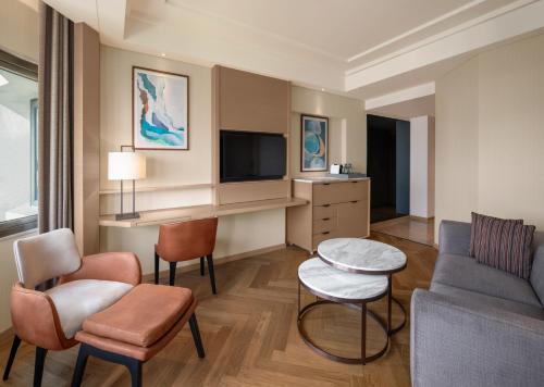 a living room with a couch and a tv at The Residency, Chennai in Chennai
