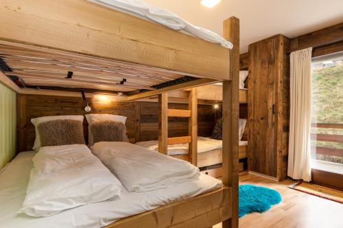 a bedroom with two bunk beds in a cabin at Les Rocailles Apartment | 9 in La Tzoumaz