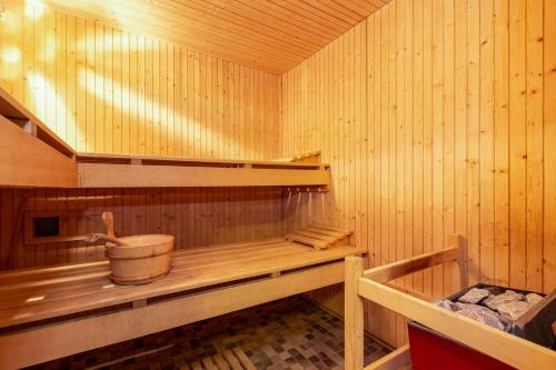 a inside of a sauna with a bucket at Les Rocailles Apartment | 9 in La Tzoumaz