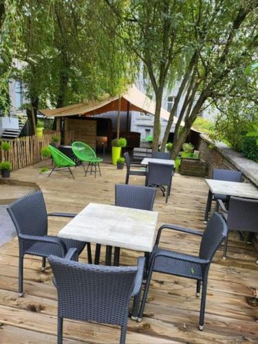 a group of tables and chairs on a patio at LA Poivriere in Durbuy nieuw appartement met gemeenschappelijke jacuzzi en sauna in Durbuy