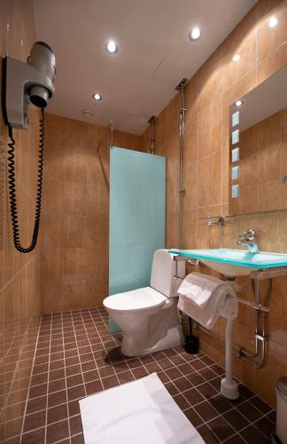 a bathroom with a toilet and a sink at Best Western Hotel Bentleys in Stockholm