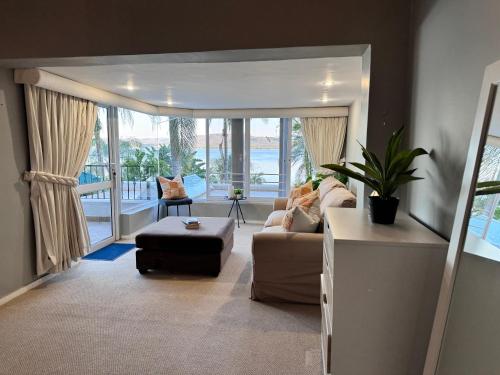 a living room with a couch and a table at Olives by Agnes in Hartbeespoort