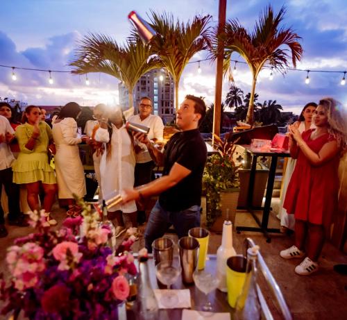 a group of people standing around a table with flowers at Townhouse Boutique Hotel in Cartagena de Indias
