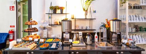 a bakery with a counter with food on it at Best Western Hotel Bentleys in Stockholm