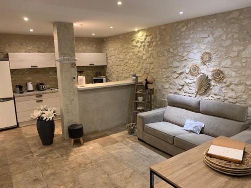 un salon avec un canapé et une cuisine dans l'établissement Un havre de paix au coeur de la Provence, à Châteaurenard