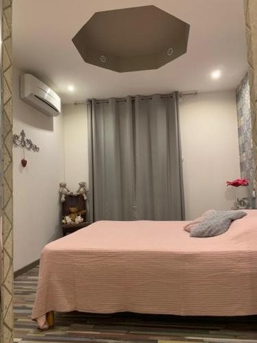 a bedroom with a large bed with a ceiling at Un havre de paix au coeur de la Provence in Châteaurenard