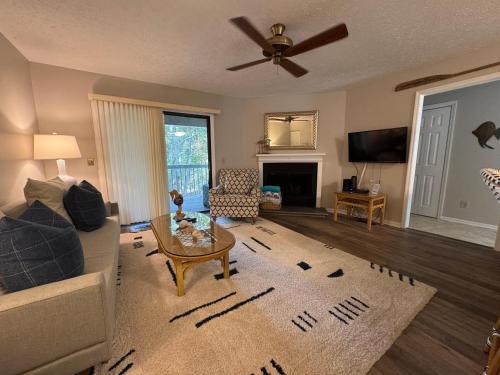 a living room with a couch and a ceiling fan at Hideaway in Southport