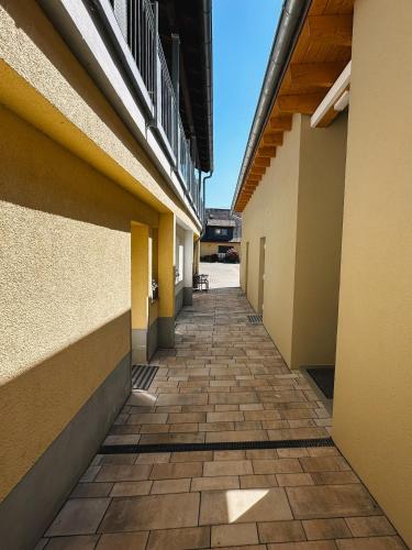 an empty hallway of a building with a tile floor at Hotel Traube Rheinhessen in Worms