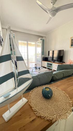 a living room with a sail boat on the floor at Luxury on the beach apartment in Hanioti