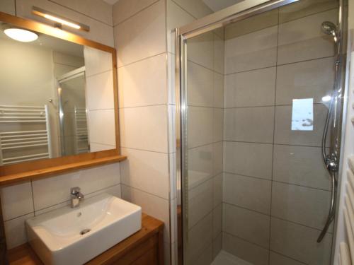a bathroom with a sink and a shower at Charmant appartement neuf avec balcon, 2 chambres, 2 SDB et parking au cœur des Saisies - FR-1-293-272 in Hauteluce