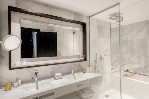 a bathroom with a sink and a shower and a mirror at Hotel de Mar Gran Meliá - Adults Only - The Leading Hotels of the World in Illetas