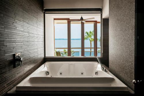 a bath tub in a bathroom with a window at Hotel de Mar Gran Meliá - Adults Only - The Leading Hotels of the World in Illetas