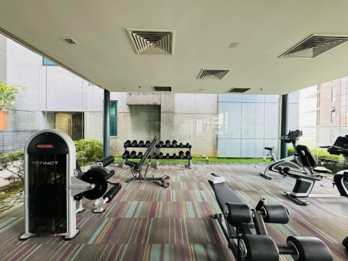 a gym with treadmills and machines in a building at Summer Suites Studio With Balcony Nearby KL City Centre in Kuala Lumpur