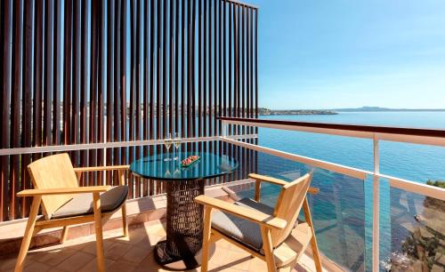 a balcony with a table and two chairs and the ocean at Hotel de Mar Gran Meliá - Adults Only - The Leading Hotels of the World in Illetas