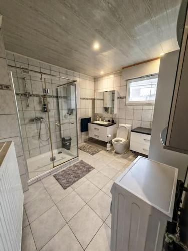 a large bathroom with a shower and a toilet at The Castle in Niel