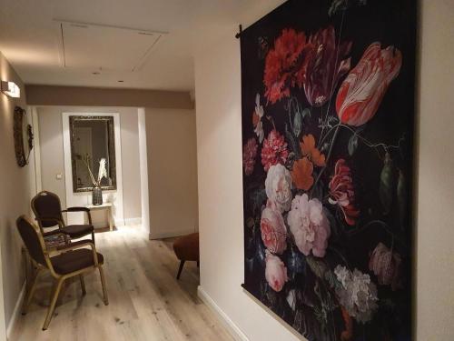 a painting of flowers on a wall in a room at Villa Burgau, C&H in Monschau