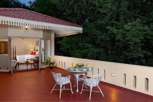 a patio with a table and chairs and a bedroom at Gateway Madurai in Madurai