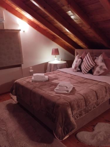 a bedroom with a large bed with towels on it at Luxury Villas Chrysa Private Pool & Spa in Nafplio