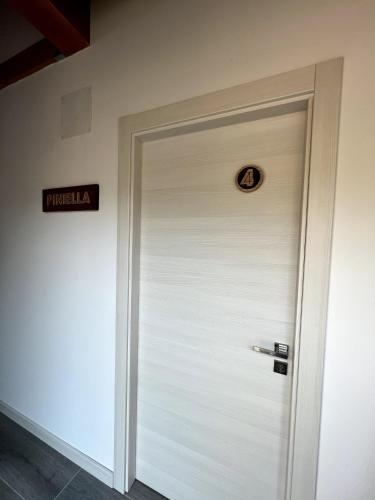 a white door in a building with a sign on it at El Hotel & SPA de Verdiago in Verdiago