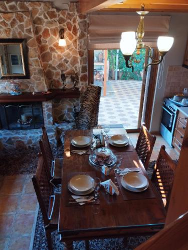 a wooden table with chairs and a dining room at Luxury Villas Chrysa Private Pool & Spa in Nafplio