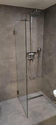 a shower with a glass door in a bathroom at The Gate Porto in Porto