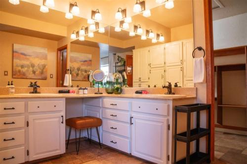 a bathroom with two sinks and a large mirror at Southwestern Desert Escape Pool, Hot, Tub, Sleeps 12 in Fountain Hills