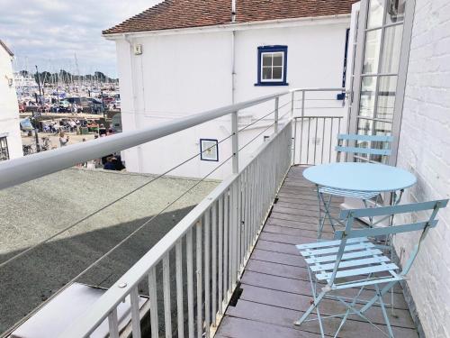 a table and a chair on a balcony at LB Newgate in Lymington