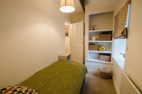 a bedroom with a green bed in a room at Swan House in Huddersfield