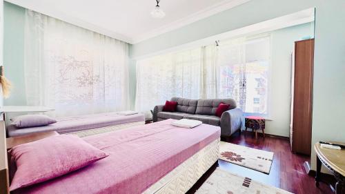 a living room with a bed and a couch at Stylish&Luxury Flat with Garden Close to Sea in Finike
